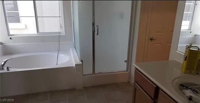 full bathroom featuring tile patterned floors, a shower stall, vanity, and a healthy amount of sunlight