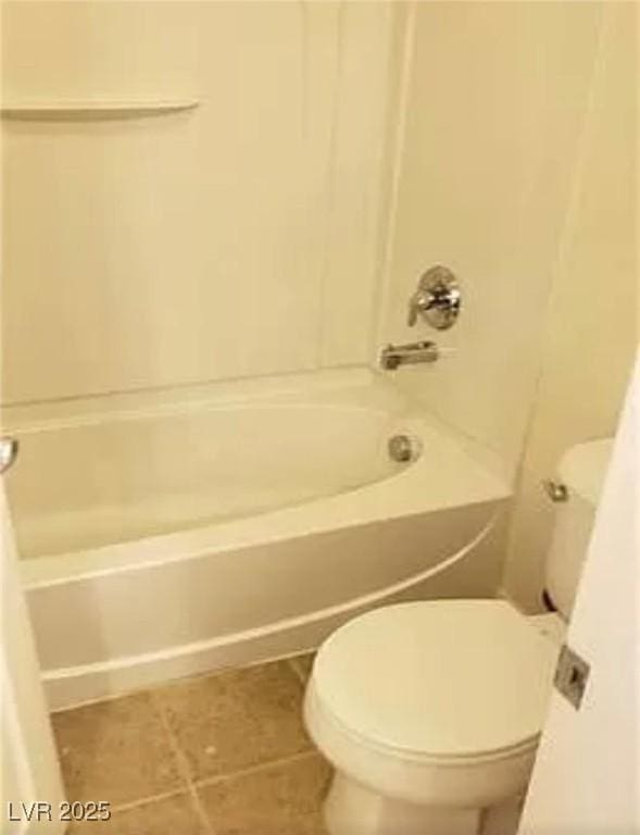 bathroom featuring  shower combination, tile patterned flooring, and toilet