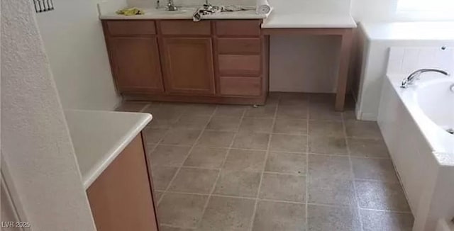 full bathroom with a sink, tile patterned flooring, and a garden tub