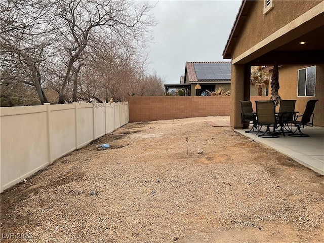 view of yard featuring a patio area and a fenced backyard