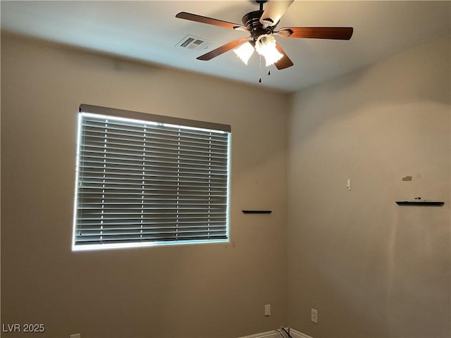 unfurnished room featuring ceiling fan and visible vents