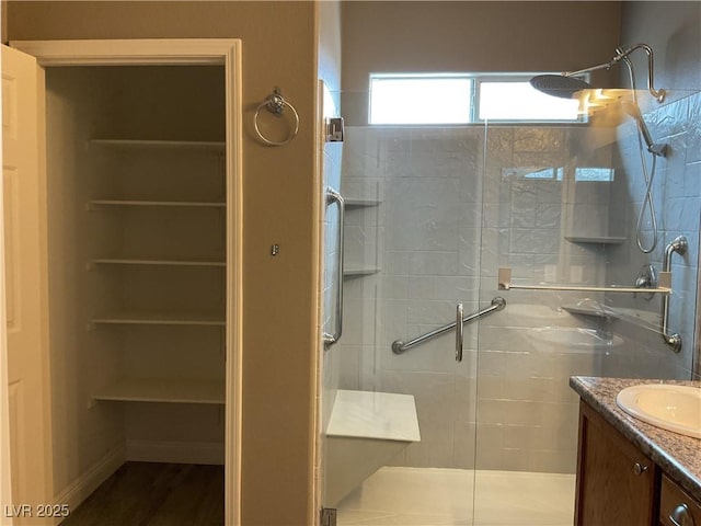 full bathroom featuring a shower stall and vanity