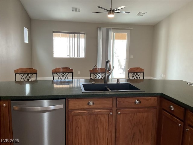 kitchen with dishwasher, a sink, visible vents, and a healthy amount of sunlight