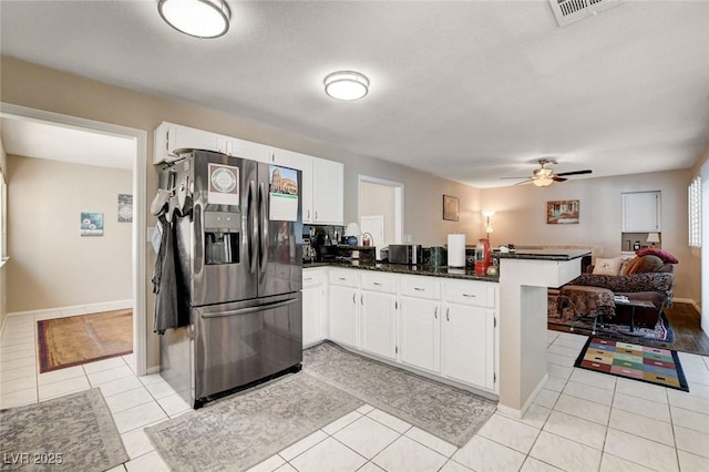 kitchen with light tile patterned floors, a peninsula, white cabinetry, open floor plan, and stainless steel refrigerator with ice dispenser