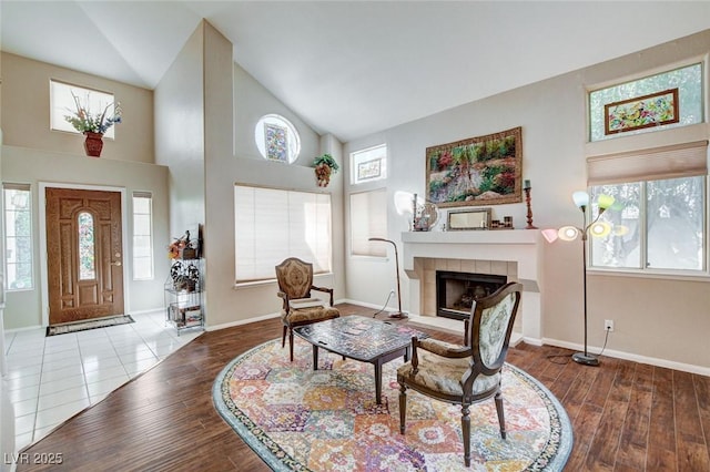 interior space with a wealth of natural light, a fireplace, and wood finished floors