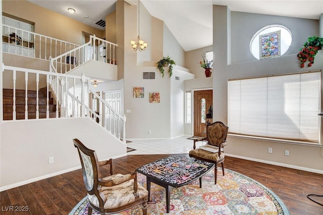 interior space featuring stairway, wood finished floors, visible vents, and a notable chandelier