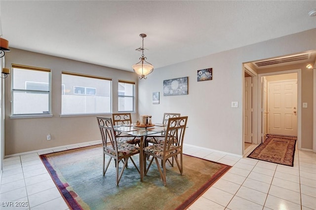 dining room featuring light tile patterned floors, baseboards, and visible vents