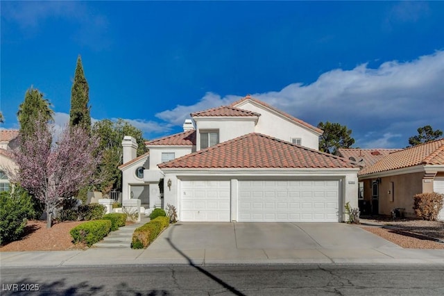 mediterranean / spanish-style home with an attached garage, driveway, a tile roof, and stucco siding