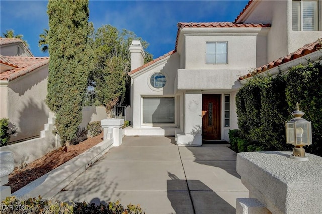 view of front of house with a tiled roof and stucco siding