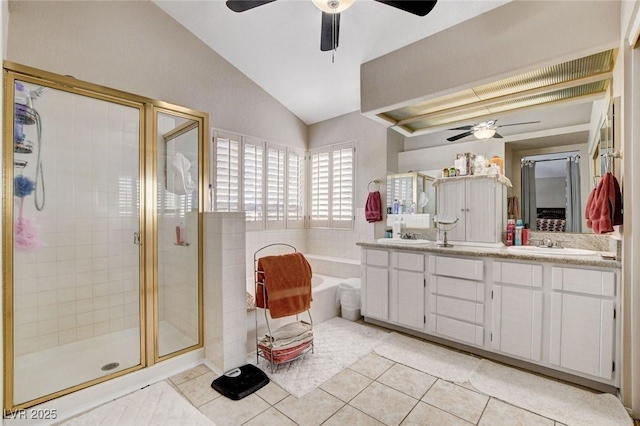 bathroom featuring double vanity, tile patterned floors, a garden tub, vaulted ceiling, and a shower stall