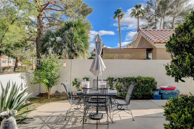 view of patio with fence and outdoor dining space