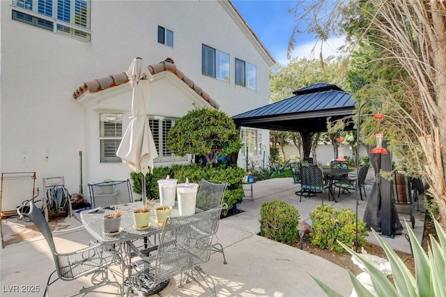 view of patio with a gazebo and outdoor dining space