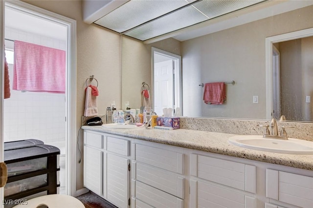 full bathroom featuring a sink and double vanity