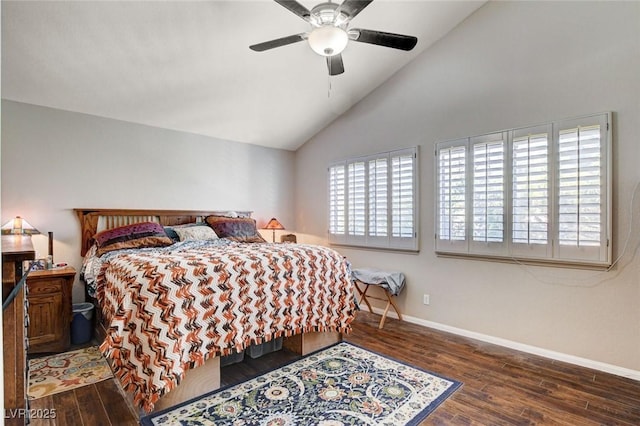 bedroom with multiple windows, baseboards, vaulted ceiling, and wood finished floors