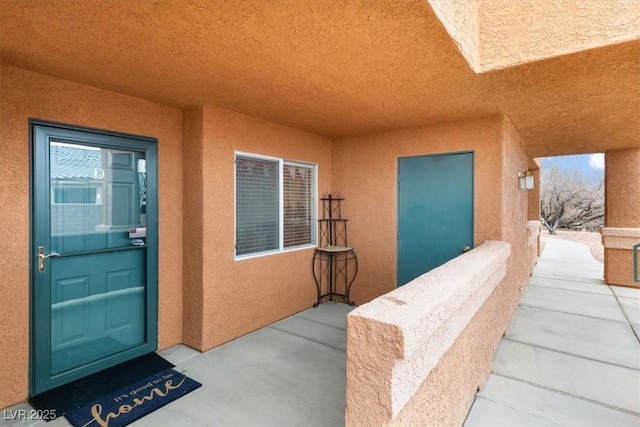 property entrance featuring stucco siding