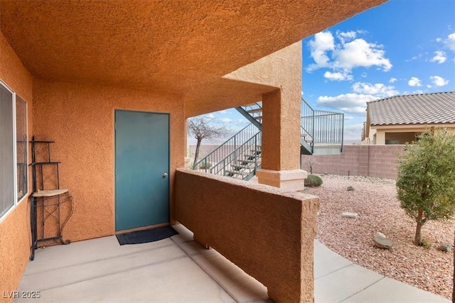 view of patio / terrace featuring a balcony and fence