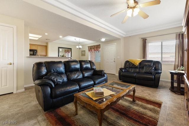 living area with light tile patterned floors, a ceiling fan, baseboards, and crown molding