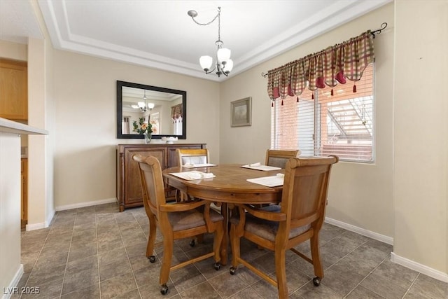 dining area with an inviting chandelier and baseboards