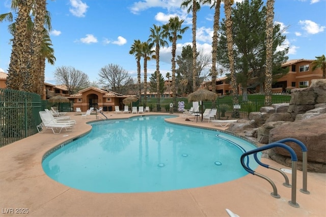 pool featuring a patio area and fence