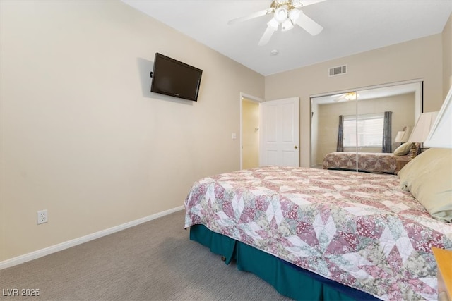 carpeted bedroom featuring ceiling fan, a closet, visible vents, and baseboards