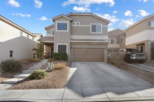 traditional home featuring driveway, an attached garage, and stucco siding