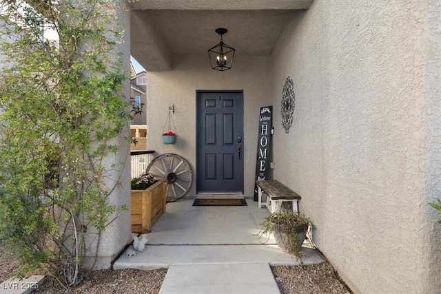 entrance to property with stucco siding