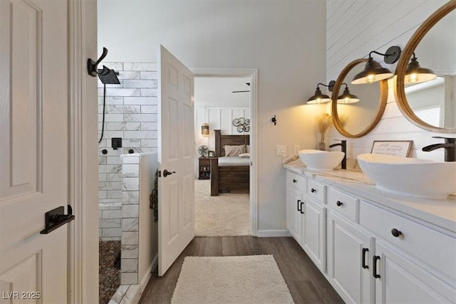 bathroom with wood finished floors, a sink, ensuite bath, and walk in shower