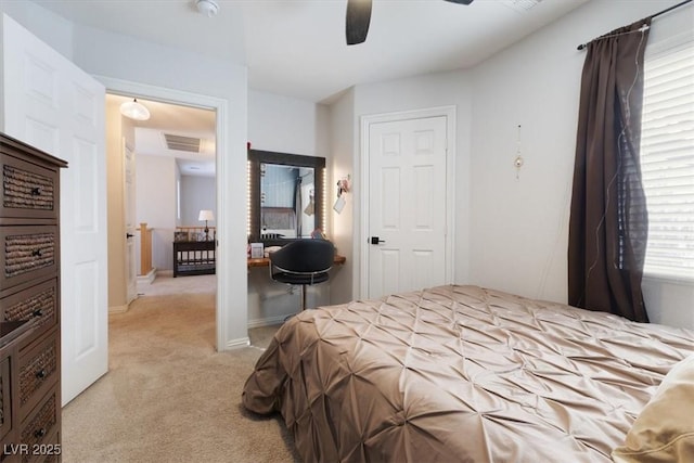 bedroom featuring a ceiling fan, light colored carpet, visible vents, and baseboards