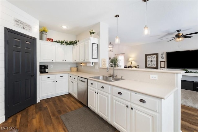 kitchen featuring dishwasher, a peninsula, dark wood-style flooring, and a sink