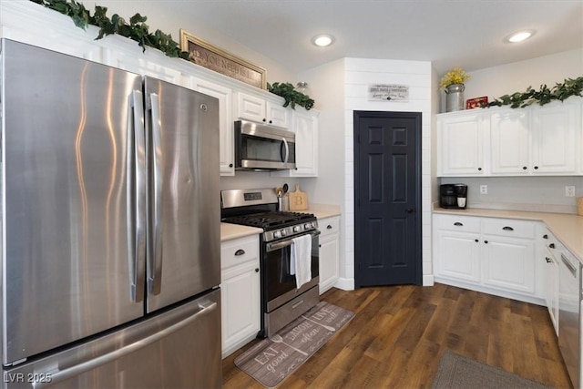 kitchen featuring recessed lighting, stainless steel appliances, white cabinetry, light countertops, and dark wood-style floors