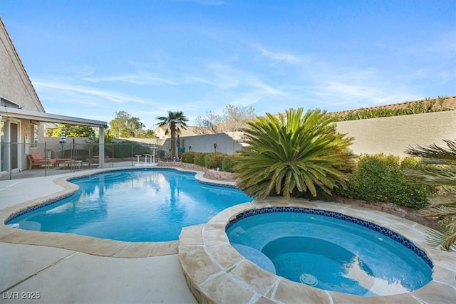 view of pool with an in ground hot tub, a patio, a fenced backyard, and a fenced in pool