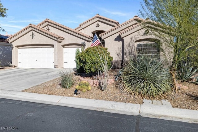 view of front facade with a garage, driveway, a tiled roof, and stucco siding