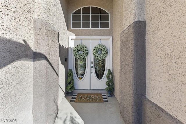 doorway to property with french doors and stucco siding