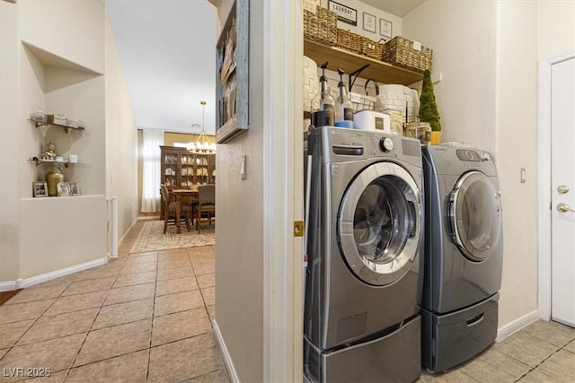 laundry room featuring laundry area, light tile patterned flooring, and washing machine and dryer