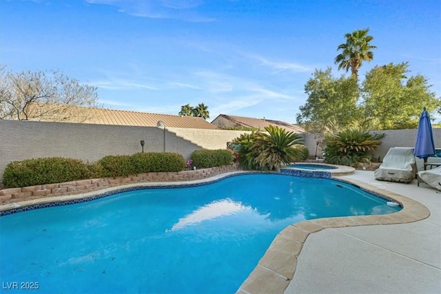 view of pool with a patio area, a fenced backyard, and a pool with connected hot tub