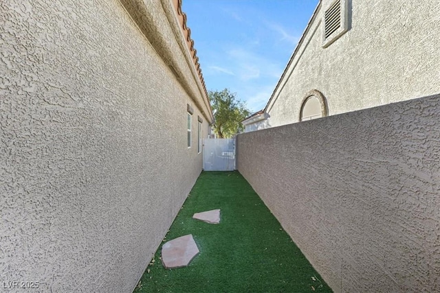 view of property exterior featuring fence and stucco siding