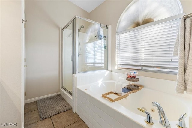 full bath with a jetted tub, a shower stall, and tile patterned floors