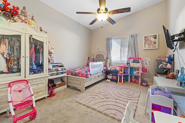 bedroom with vaulted ceiling, a ceiling fan, and light colored carpet