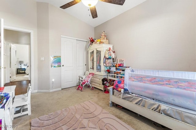 bedroom featuring lofted ceiling, a closet, carpet flooring, and baseboards