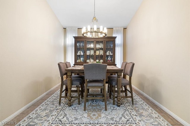 dining room featuring baseboards and a chandelier