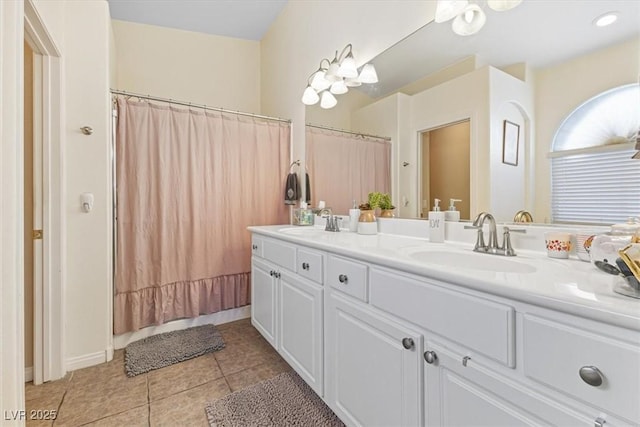 full bathroom featuring double vanity, curtained shower, tile patterned flooring, and a sink