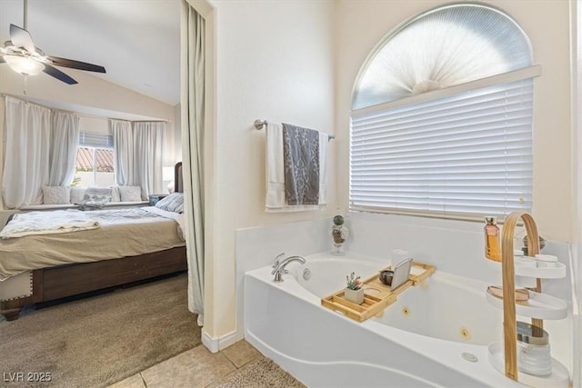 bathroom featuring lofted ceiling, ensuite bathroom, a ceiling fan, a whirlpool tub, and tile patterned floors