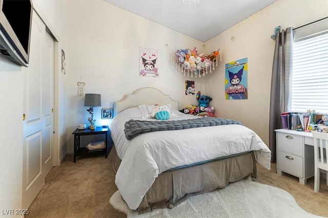 bedroom with light carpet and a closet