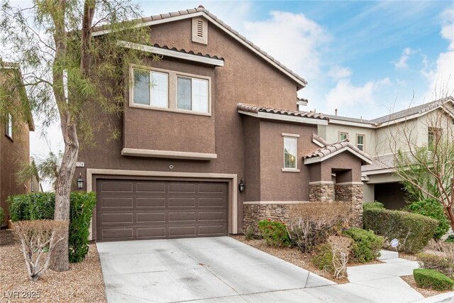 view of front facade with a garage, stone siding, concrete driveway, a tiled roof, and stucco siding