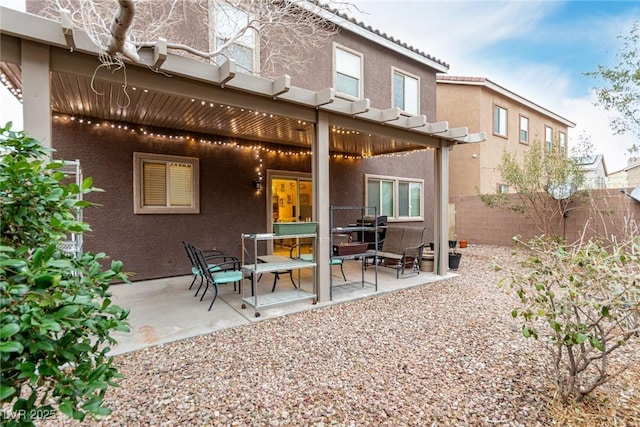 back of house with a patio, a tile roof, fence, a pergola, and stucco siding