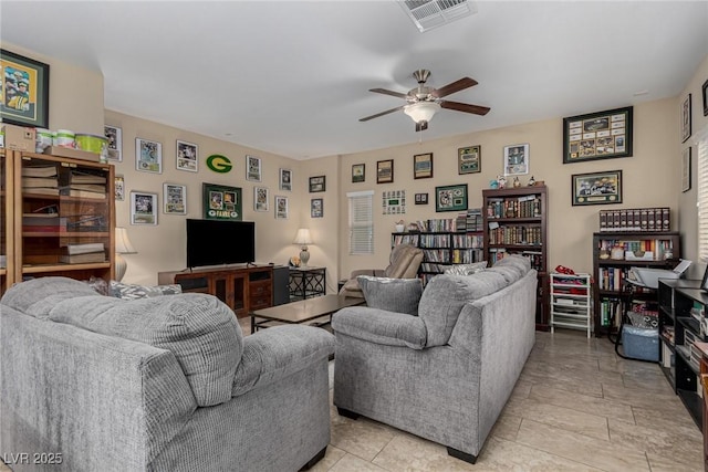 living area with visible vents and a ceiling fan