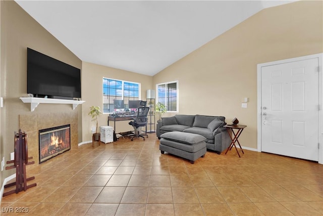 living room with high vaulted ceiling, baseboards, a tiled fireplace, and light tile patterned floors