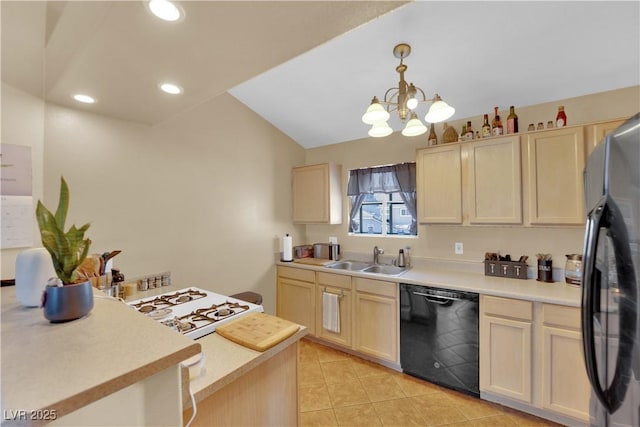 kitchen featuring light countertops, a sink, black appliances, and light tile patterned flooring