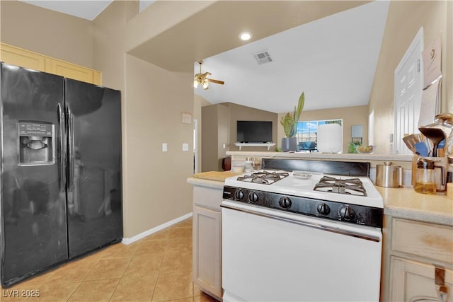 kitchen featuring light tile patterned floors, white range with gas stovetop, a ceiling fan, black fridge with ice dispenser, and light countertops