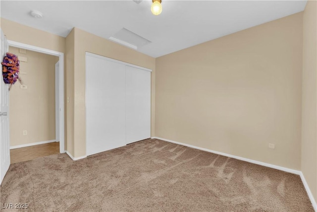 unfurnished bedroom with carpet, baseboards, and a closet